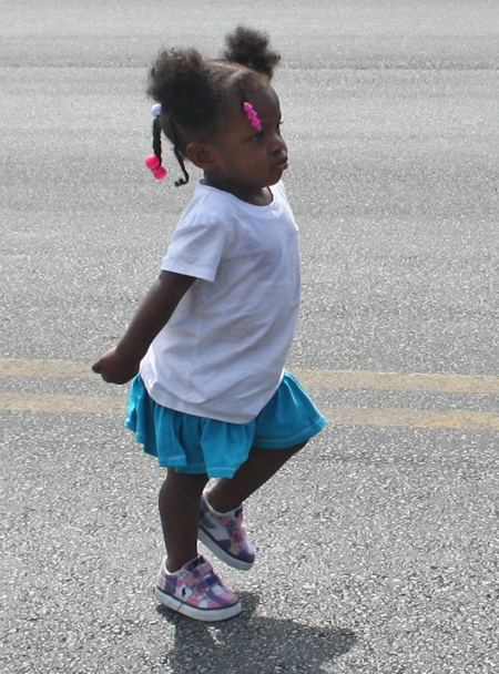 very young girl dancing and marching in Parade