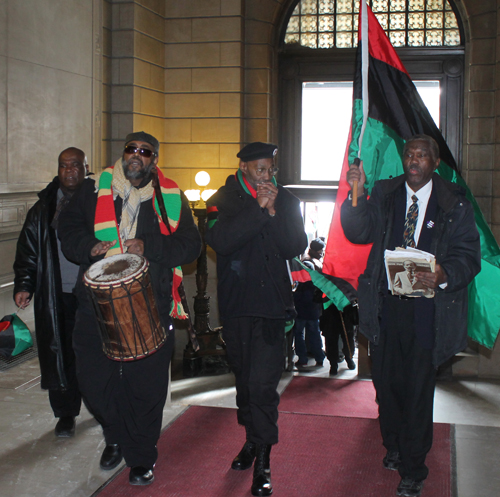Marching with red, green and black flag