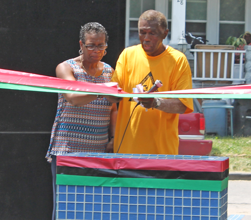 Eugene Jordan and former Councilwoman Sabra Pierce Scott cut the ribbon for Phase 1 in the African American Garden in Cleveland