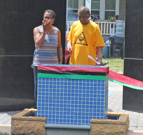 Eugene Jordan and former Councilwoman Sabra Pierce Scott cut the ribbon for Phase 1 in the African American Garden in Cleveland