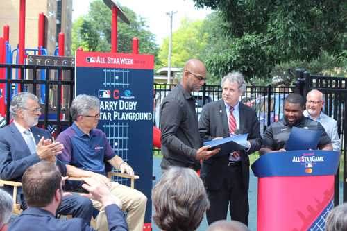 Senator Sherrod Brown presents a proclamation to Larry Doby Jr.