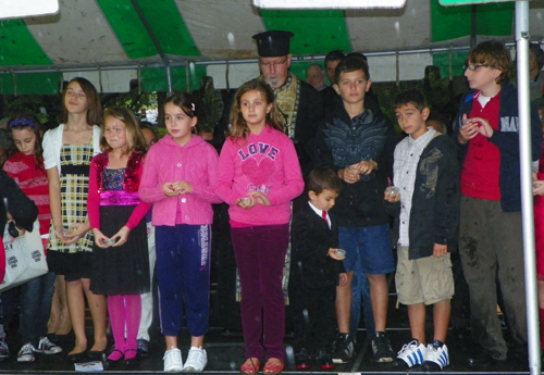 Albania American children sprinkle soil from Albania in Cleveland Garden