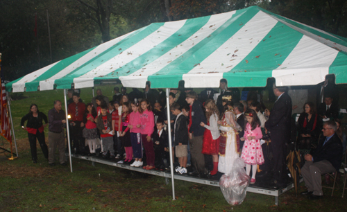 Albania American children sprinkle soil from Albania in Cleveland Garden