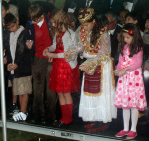 Albania American children sprinkle soil from Albania in Cleveland Garden