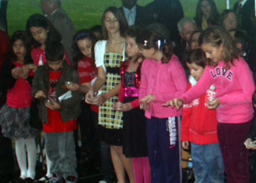 Albania American children sprinkle soil from Albania in Cleveland Garden