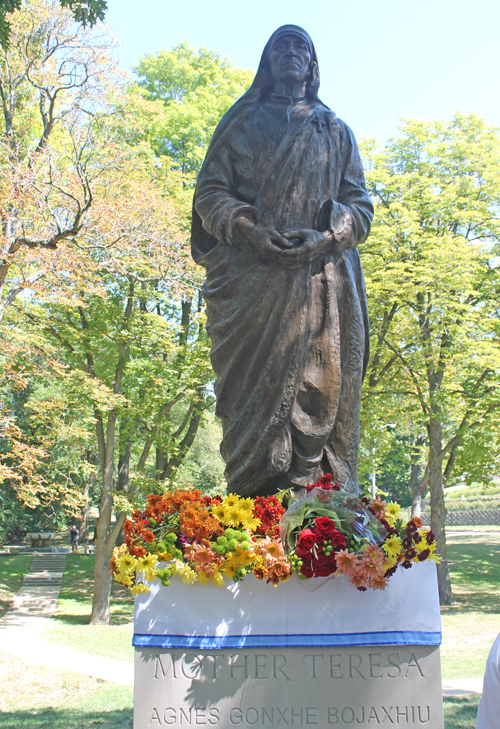 Flowers at base of Mother Teresa Statue in Albanian Cultural Garden in Cleveland