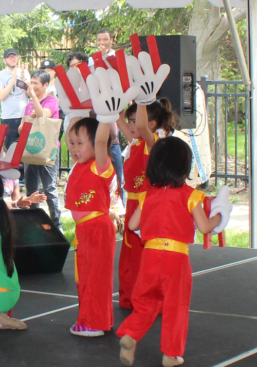 Young girls Chinese dance with big gloved hands