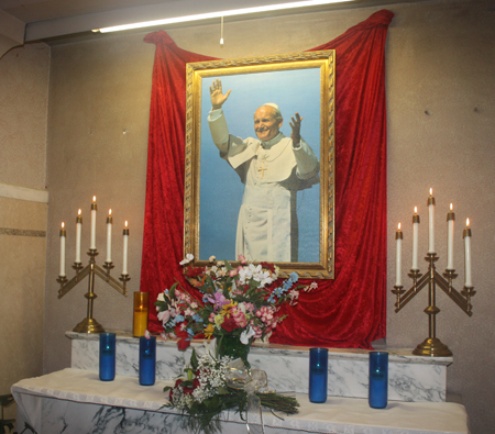 Flowers at photo of Pope John Paul II