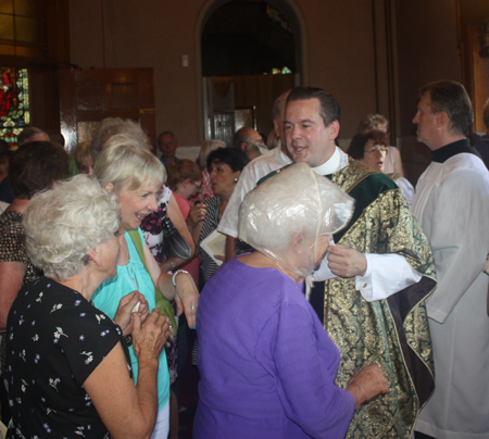 Fr Eric Orzech shaking hands