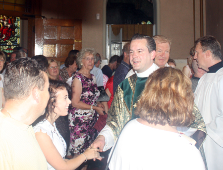 Fr Eric Orzech shaking hands