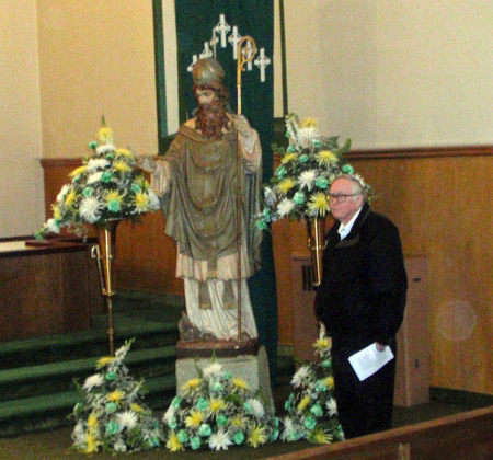 Posing by statue of St. Patrick