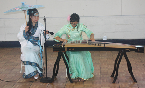 Demi Zhang plays the 21 string Chinese zither (guzheng) and her mother Bing Xu sings