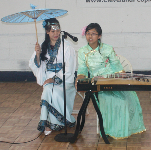 Demi Zhang plays the 21 string Chinese zither (guzheng) and her mother Bing Xu sings