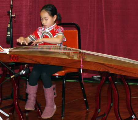 8 year old girl from Cleveland Chinese Music Group playing guzheng