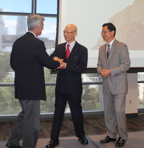 Dr. Anthony Yen and Dr. Jianping Zhu hand a proclamatiopn to Ron Abate