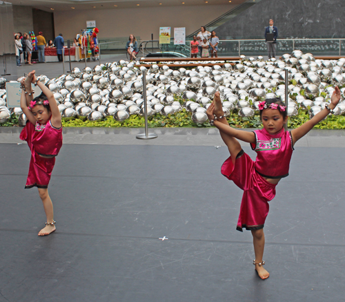 3 young girls doing an acrobatic Chinese dance