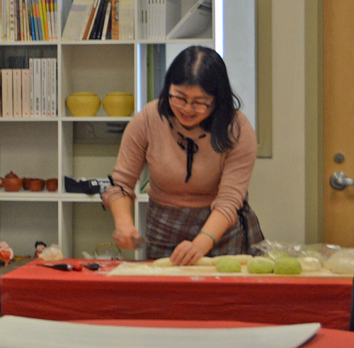 Yufei Guo demonstrates how to roll out dumpling wrappers