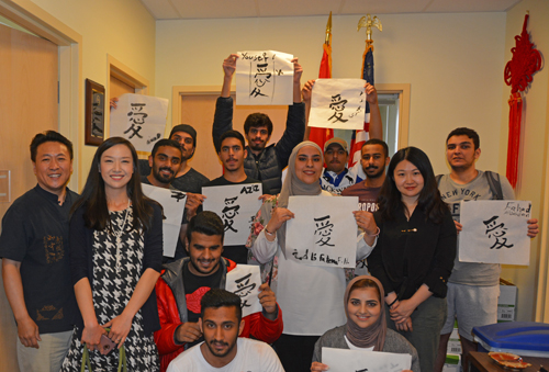 Participants show their calligraphy works with Huiwen Li, Ni Zhang, and Xiaocong Ding