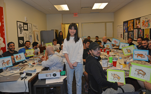 Participants show the Chinese Zodiac gift paintings drawn by Yufei Li