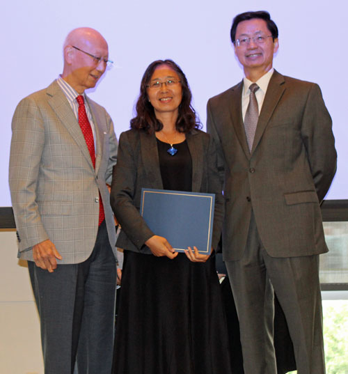 Dr. Anthony Yen and Dr. Jianping Zhu present award to teacher  Xuhong Zhang