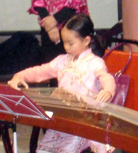 Very young girl from Cleveland Chinese Music Group plays guzheng