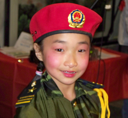 Young Chinese girls perform acrobatics in military costumes