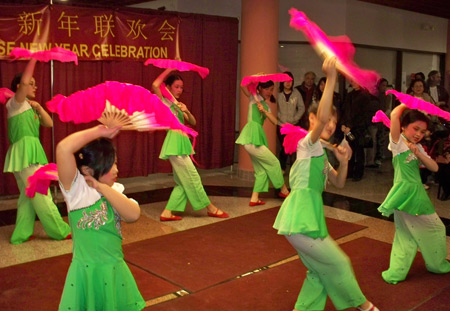 Young Chinese girls perform acrobatics with fans