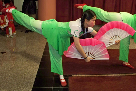 Young Chinese girls perform acrobatics with fans
