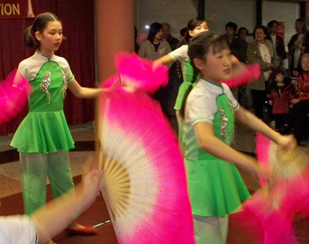 Young Chinese girls perform acrobatics with fans