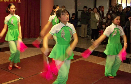 Young Chinese girls perform acrobatics with fans