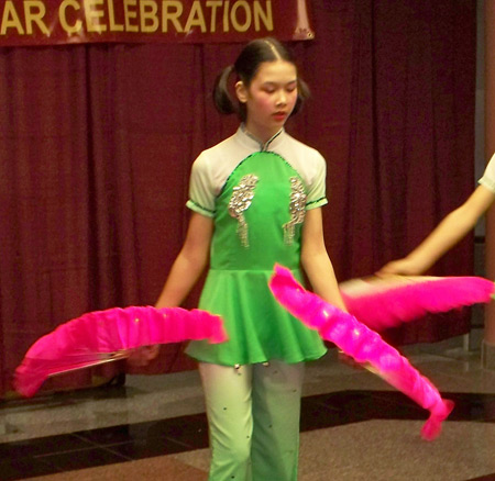 Young Chinese girls perform acrobatics with fans