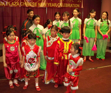 Young Chinese girls perform acrobatics with fans