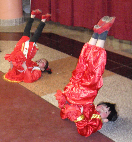 Chinese boy and girl perform acrobatic dance for New Years