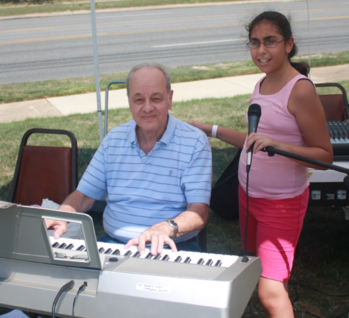 Man playing keyboards with girl