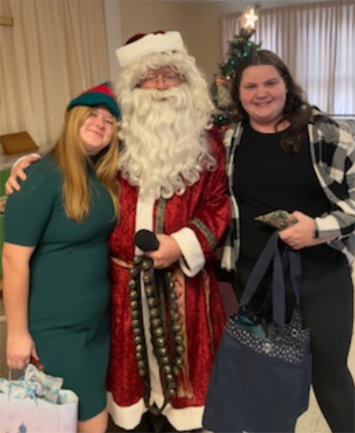 Elyse Champa and Emmi Puussaar were Santas elves, helping carry the gifts