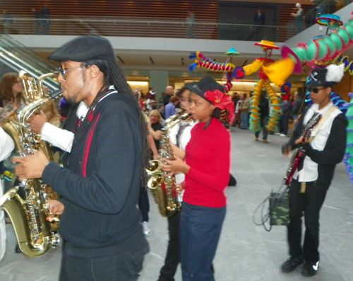 Members of the musical group Progeny from Shaw High School and Heritage Middle School paraded through the new Ames Family Atrium with the Quixote puppets from Parade the Circle.