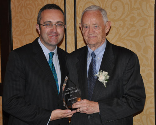 Consul General Aidan Cronin hands Jack Coyne his Cleveland International Hall of Fame award