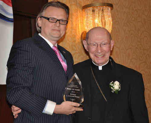 Consul General of Slovenia Jure Zmauc hands Bishop Edward Pevec his Cleveland International Hall of Fame award