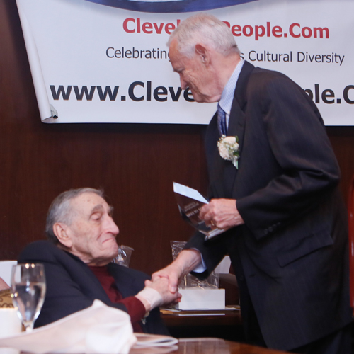 Fellow inductee Sam Miller congratulates Jack Coyne