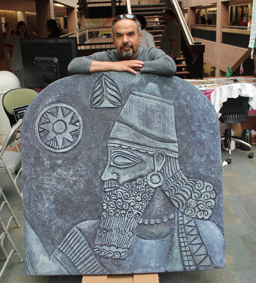 Iraqui artist Ahmed Gareeb behind one of his pieces