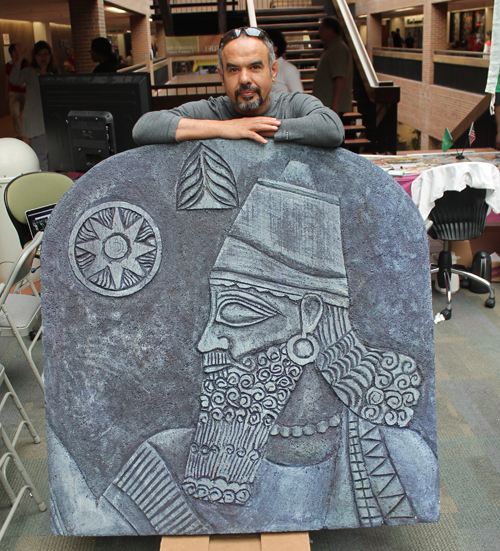 Iraqui artist Ahmed Gareeb behind one of his pieces