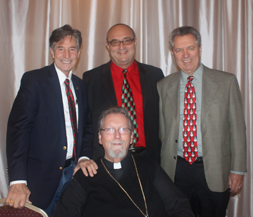 Jim Craciun, Robert Filippi and Ralph Perh Jr. behind Rev Fr. John Loejos