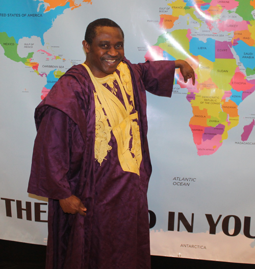 Posing with a map of Cameroon