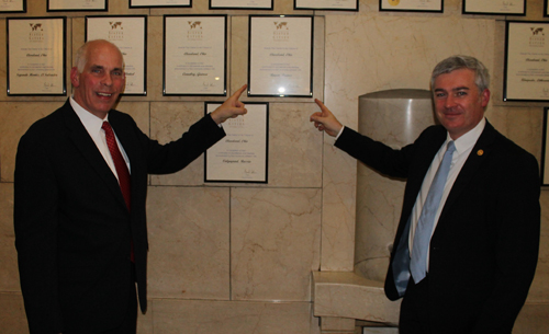 Larry Miller and Mr. Stphane Bordier point to the Sister Cities plaque