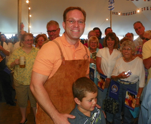 Meteorologist Scott Sabol of Fox 8 TV Cleveland taps the keg at Oktoberfest