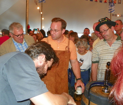 Meteorologist Scott Sabol of Fox 8 TV Cleveland taps the keg at Oktoberfest