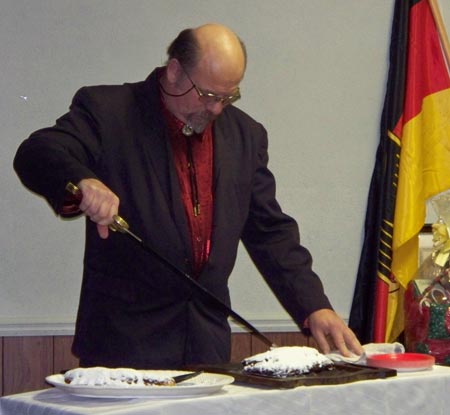 David Jakupca cuts the stollen with a sword