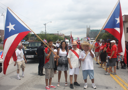 Councilman Matt Zone and wife Michelle flanked by Puerto Rican flags