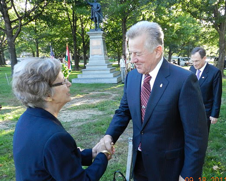 Edith Lauer greets President Schmitt at the Kossuth statue