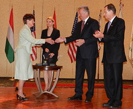 Jeanette Grasselli Brown accepts her award (President's Medal Of Merit) from Hungarian President Pal Schmitt after Ambassador Dr. Gyorgy Szapary introduced her